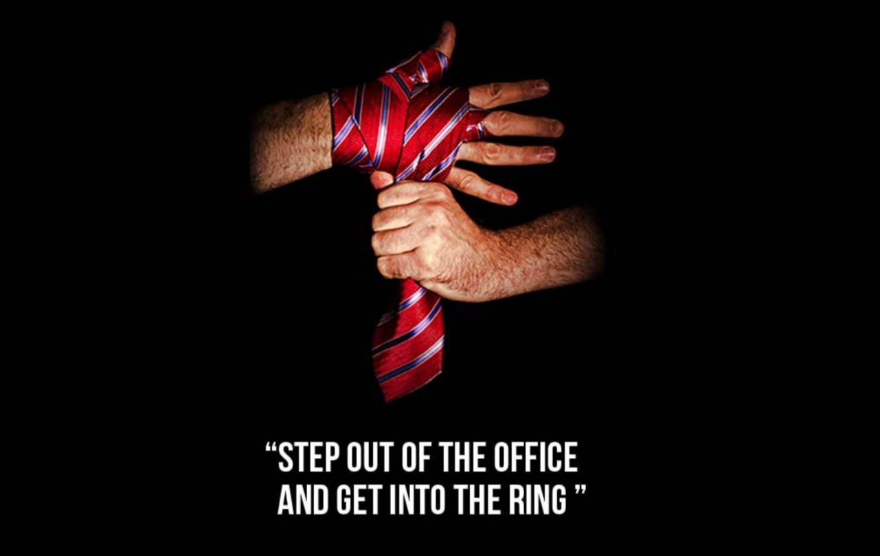 A red striped silk tie wrapped as a boxing hand wrap. Step out of the office and get into the ring.